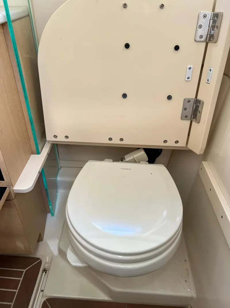 Slide: The Image of 2013 Boston Whaler 370 Outrage marine toilet in cabin. - 24