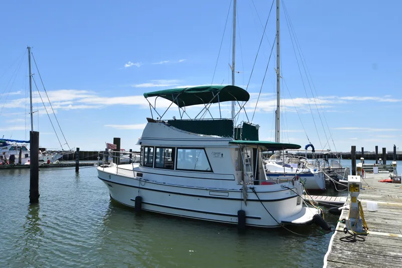 Slide: The Image of 2001 Camano 31 Trawler docked at a marina on a sunny day. - 0