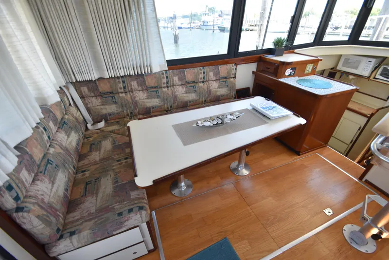 Slide: The Image of Interior of 2001 Camano 31 Trawler with dining area and kitchenette. - 16