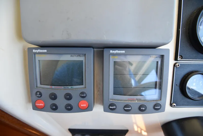 Slide: The Image of Raytheon autopilot and tridata displays on 2001 Camano 31 Trawler. - 19