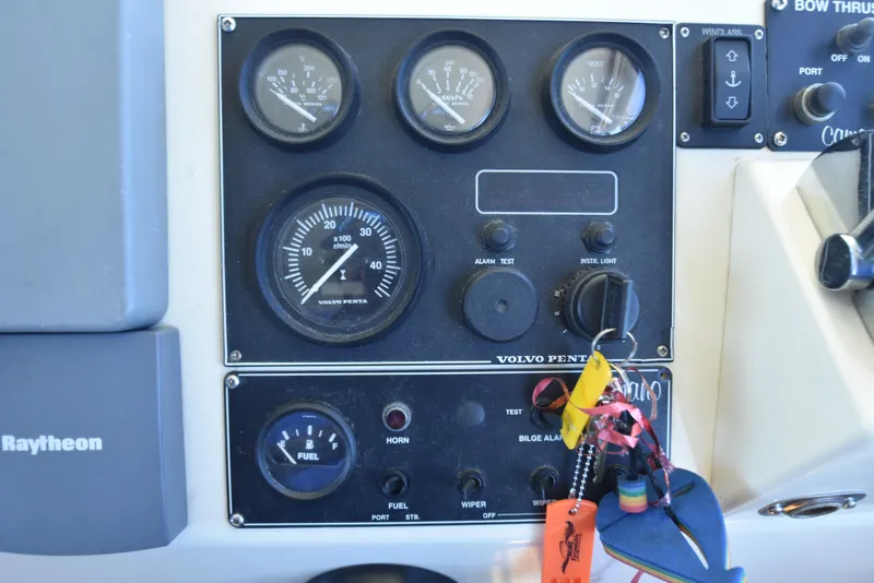 Slide: The Image of Control panel of a 2001 Camano 31 Trawler with Volvo Penta gauges and Raytheon equipment. - 30