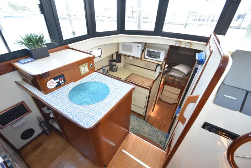 Slide: The Image of Interior of 2001 Camano 31 Trawler with kitchen, dining area, and sleeping quarters. - 31