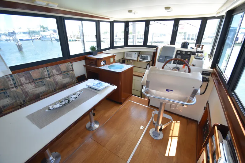 Slide: The Image of Interior of 2001 Camano 31 Trawler with helm, seating, and kitchenette. - 4