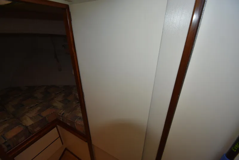 Slide: The Image of Interior cabin view of a 2001 Camano 31 Trawler with patterned cushions. - 43