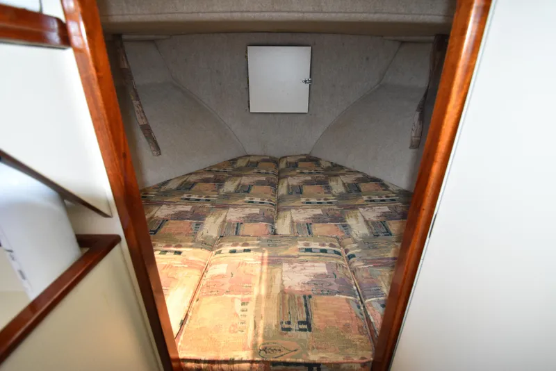 Slide: The Image of 2001 Camano 31 Trawler cabin with patterned bedding and wooden trim. - 48
