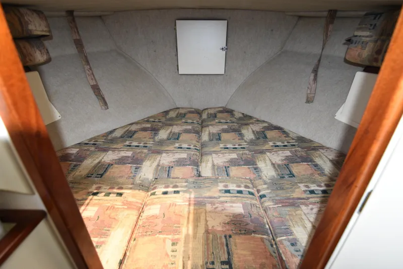 Slide: The Image of 2001 Camano 31 Trawler cabin interior with patterned bedding. - 49