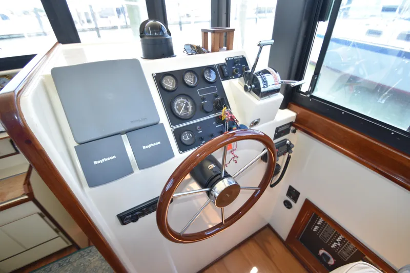 Slide: The Image of Helm station of a 2001 Camano 31 Trawler with Raytheon navigation equipment. - 7