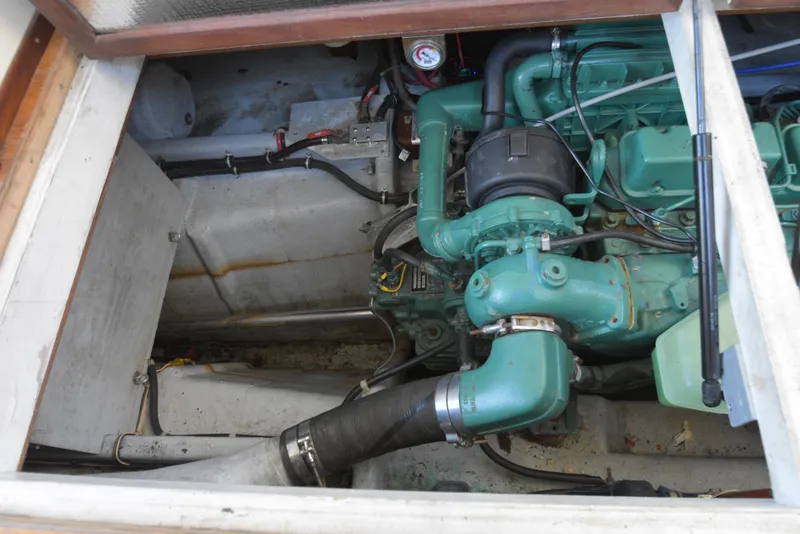 Slide: The Image of Engine compartment of a 2001 Camano 31 Trawler with visible green engine components. - 9