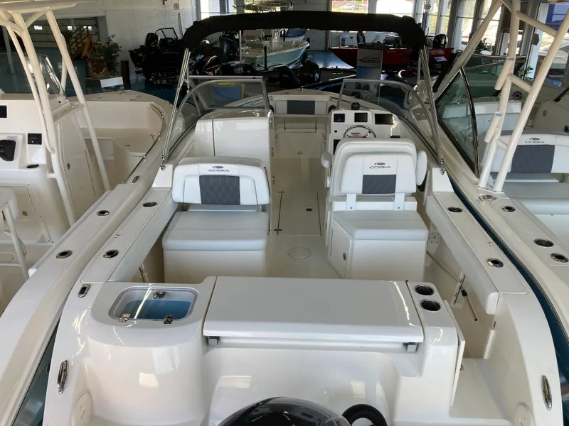 Slide: The Image of 2022 Cobia 220 Dual Console boat interior with seating and dashboard. - 4