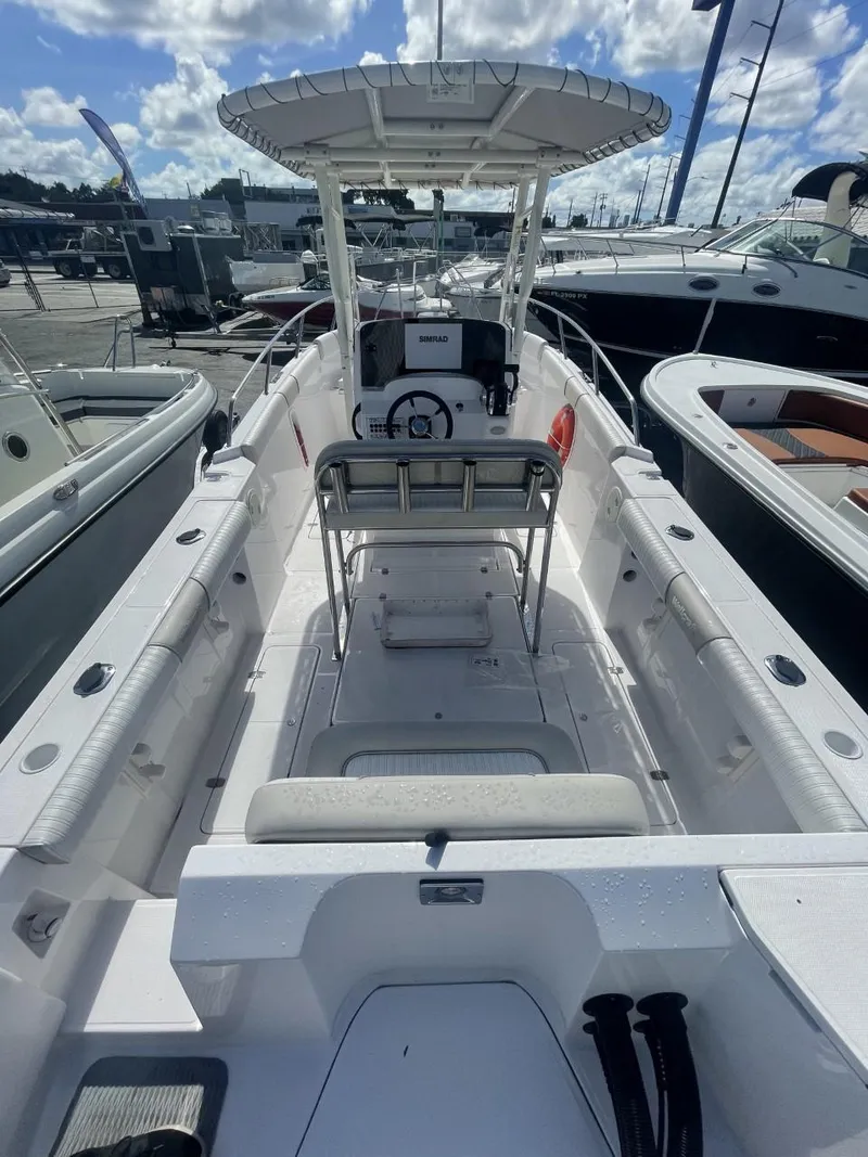 Slide: The Image of 2022 Wellcraft 275cc center console boat docked at a marina. - 10