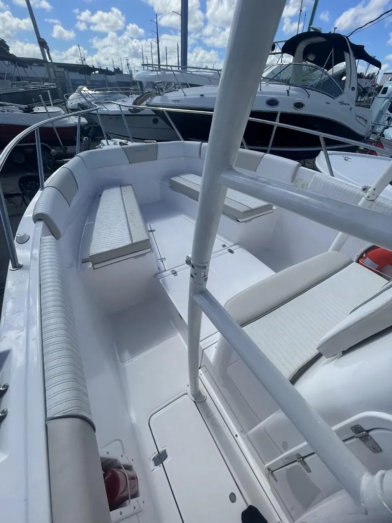 Slide: The Image of 2022 Wellcraft 275cc boat interior with seating and railing. - 13