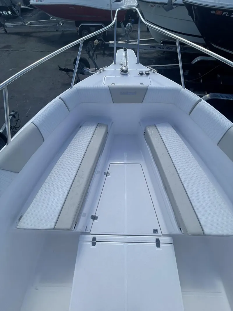 Slide: The Image of 2022 Wellcraft 275cc boat interior with white seating and stainless steel railings. - 14