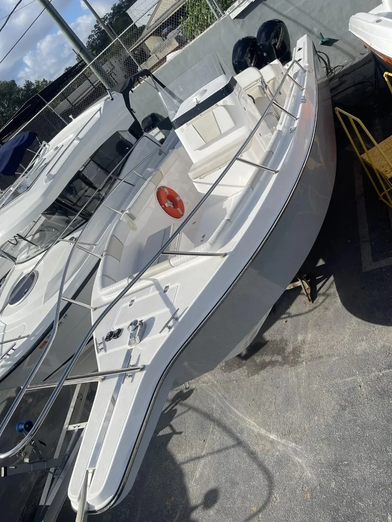 Slide: The Image of 2022 Wellcraft 275cc boat docked in a marina. - 3