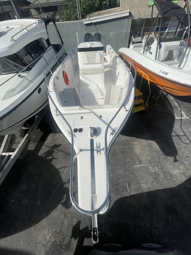 Slide: The Image of 2022 Wellcraft 275cc boat docked among other boats. - 4