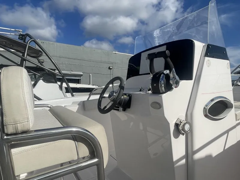 Slide: The Image of 2022 Wellcraft 275cc boat cockpit with steering wheel and controls. - 7