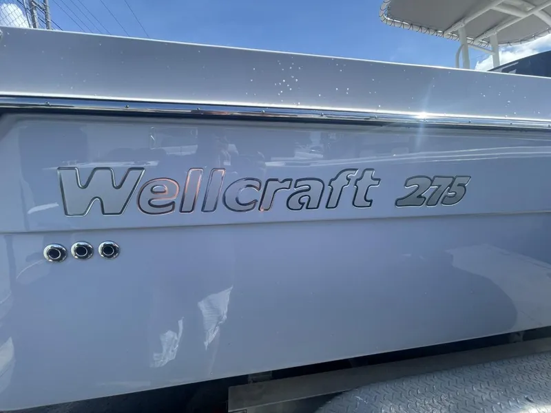 Slide: The Image of 2022 Wellcraft 275cc boat side view with logo and chrome accents. - 8