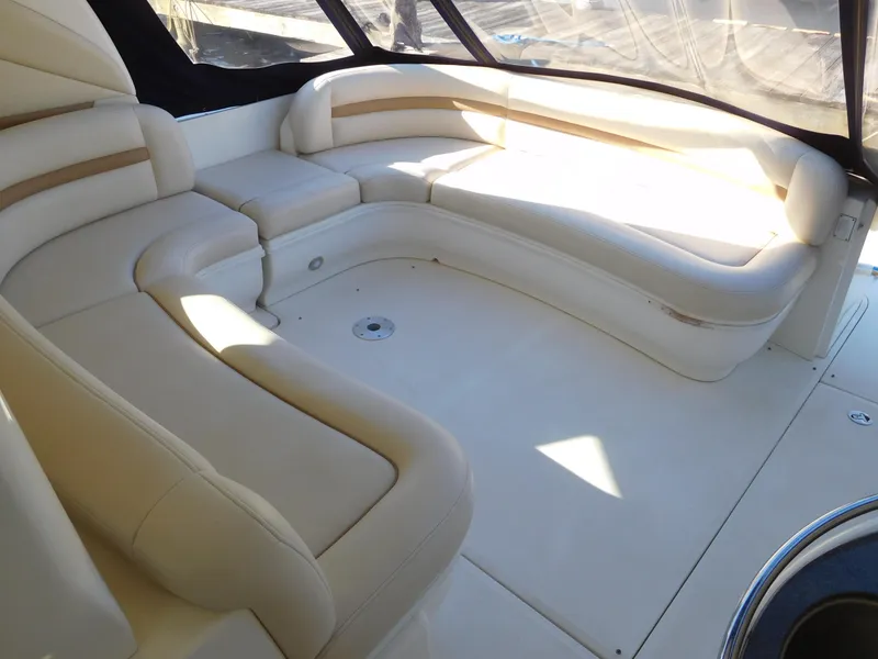 Slide: The Image of 2005 Sea Ray 420 Sundancer interior seating area with beige upholstery. - 12