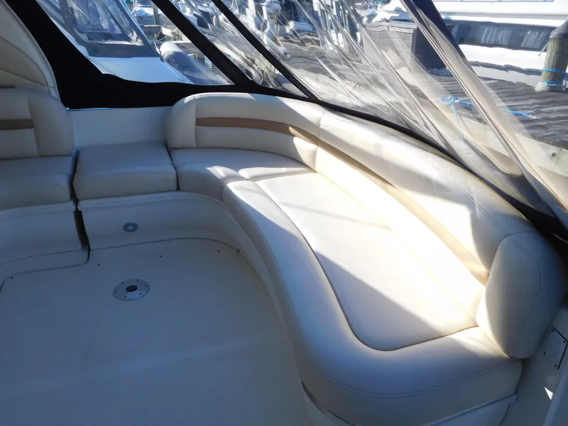 Slide: The Image of 2005 Sea Ray 420 Sundancer interior seating area with white leather upholstery. - 13