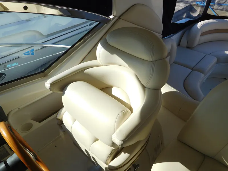 Slide: The Image of Captain's chair on 2005 Sea Ray 420 Sundancer yacht, luxurious white leather seating. - 20