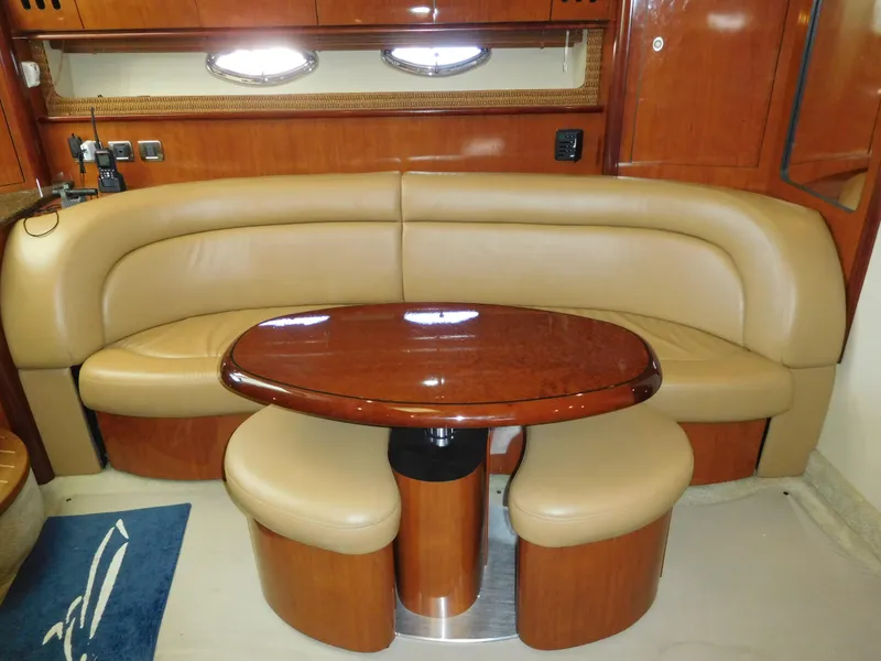 Slide: The Image of Luxurious interior of 2005 Sea Ray 420 Sundancer with leather seating and polished wood table. - 30