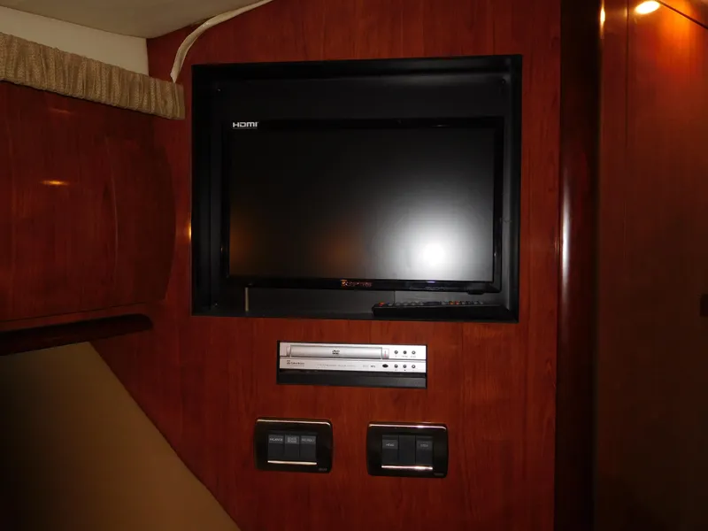 Slide: The Image of Flat-screen TV and control panel in 2005 Sea Ray 420 Sundancer yacht interior. - 43