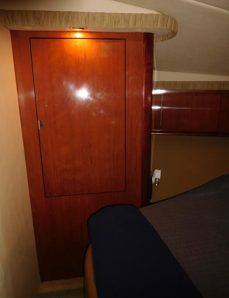 Slide: The Image of Interior cabin of a 2005 Sea Ray 420 Sundancer yacht with wooden closet. - 44