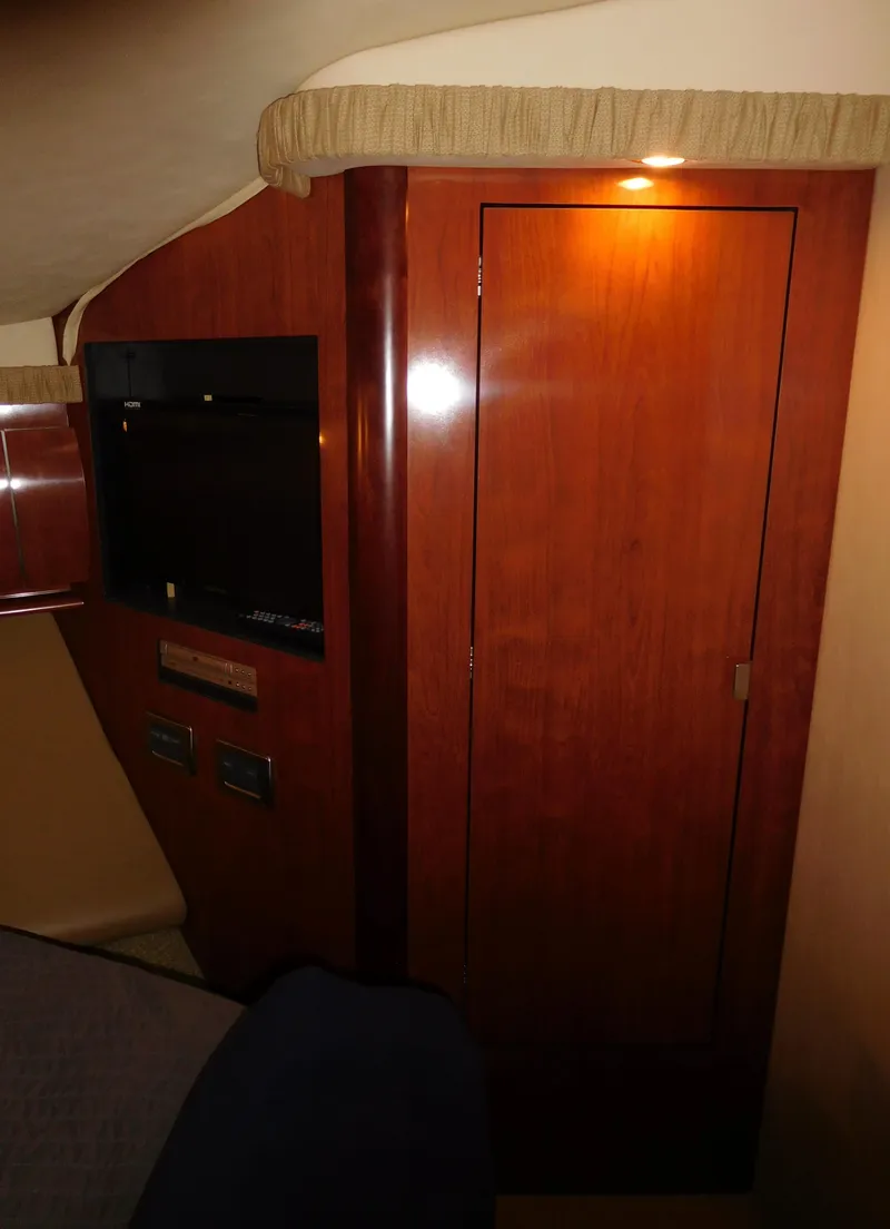 Slide: The Image of Interior cabin of 2005 Sea Ray 420 Sundancer with wooden cabinetry and TV. - 45