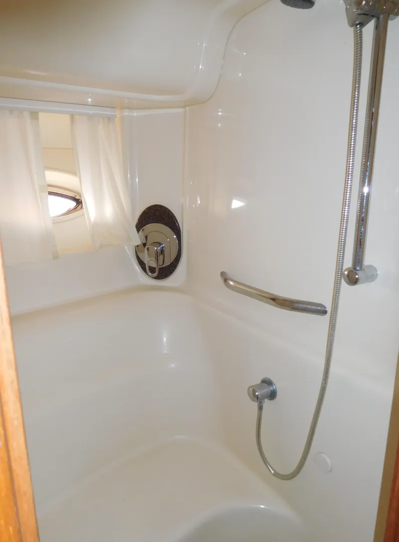Slide: The Image of Shower area in 2005 Sea Ray 420 Sundancer yacht with white interior and chrome fixtures. - 47