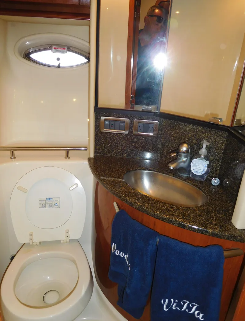 Slide: The Image of 2005 Sea Ray 420 Sundancer bathroom with sink, toilet, and mirror. - 49