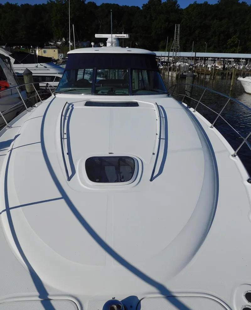 Slide: The Image of 2005 Sea Ray 420 Sundancer yacht docked at a marina. - 7