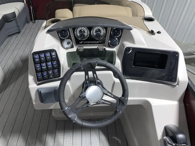 Slide: The Image of 2024 Starcraft SLS 3 boat dashboard with steering wheel and control panel. - 4