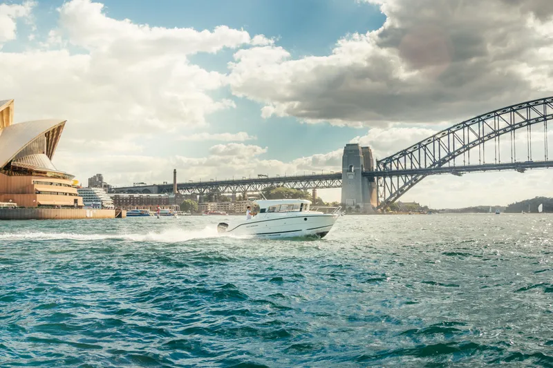 Slide: The Image of Parker Poland 800 Weekend 2022 boat cruising near iconic bridge and opera house. - 25