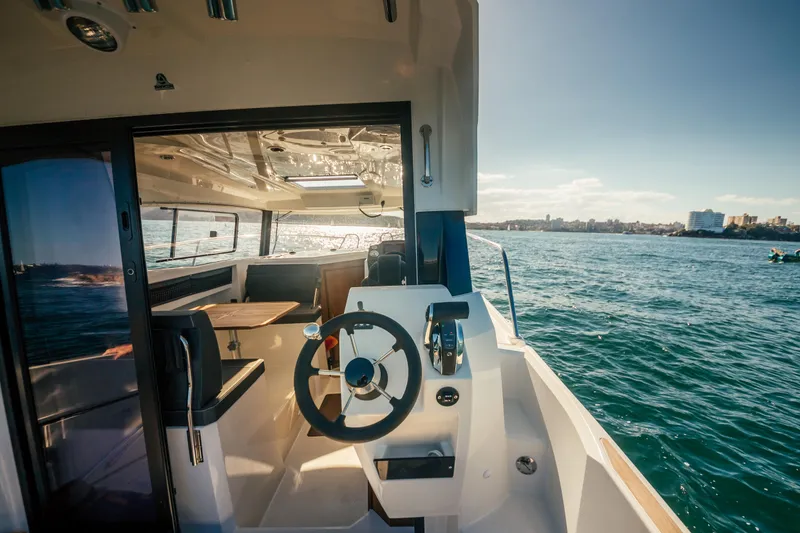 Slide: The Image of 2022 Parker Poland 800 Weekend boat interior with steering wheel, on open water. - 29