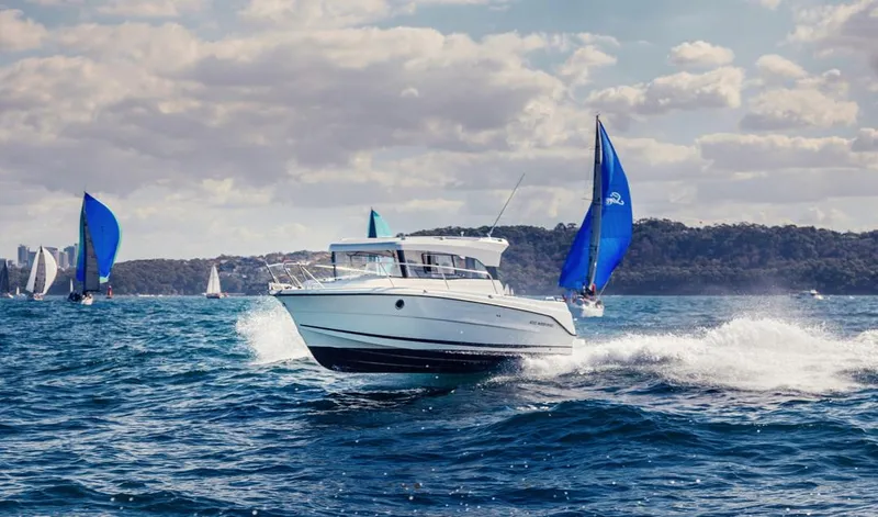 Slide: The Image of Parker Poland 800 Weekend 2022 boat cruising on a sunny day with sailboats nearby. - 40