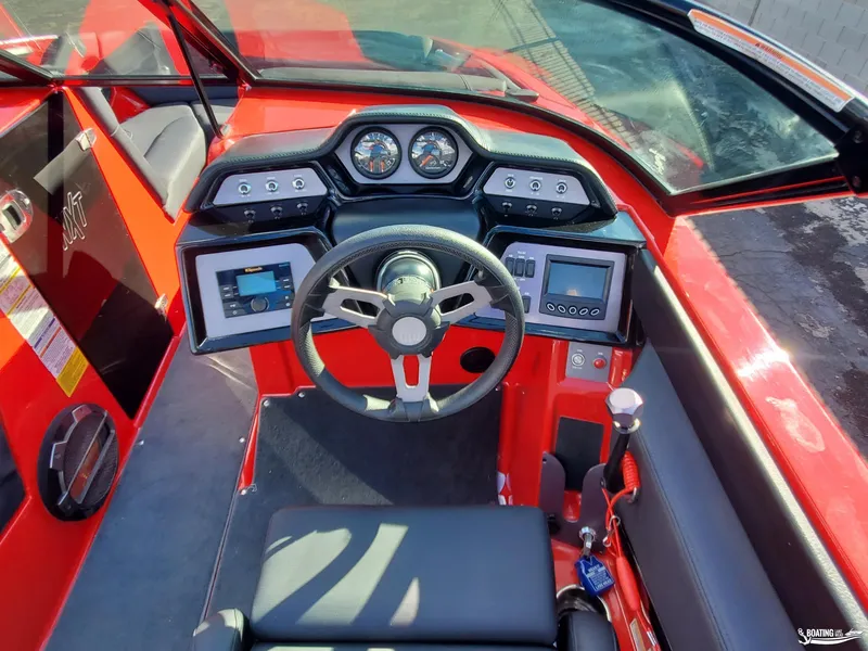 Slide: The Image of 2020 MasterCraft NXT20 boat dashboard with steering wheel and control panels. - 12