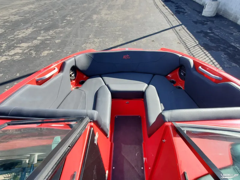 Slide: The Image of 2020 MasterCraft NXT20 boat interior with red and gray seating. - 16