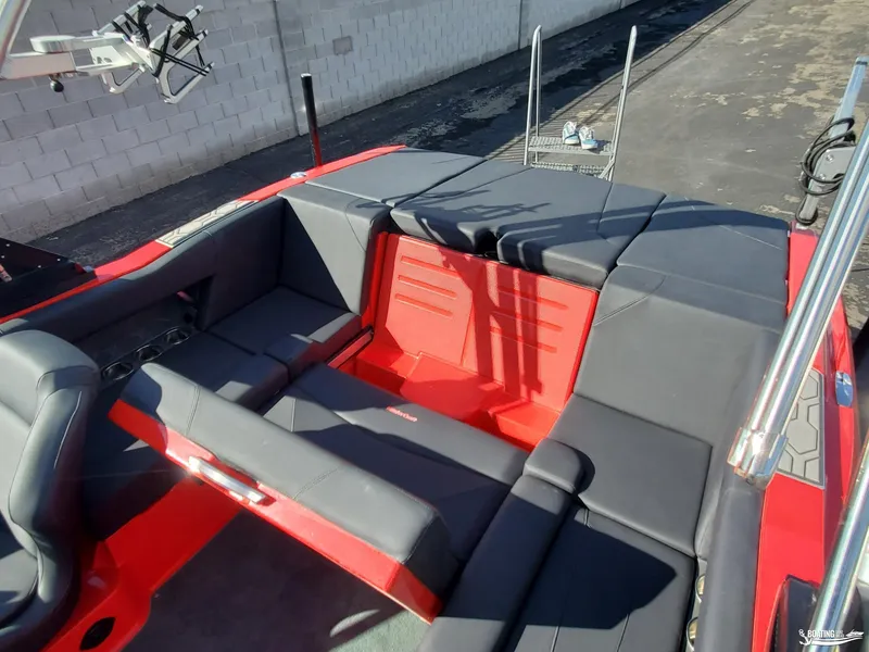 Slide: The Image of 2020 MasterCraft NXT20 boat interior with red and black seating. - 18