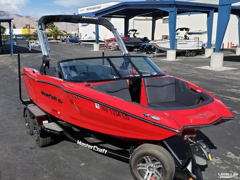 Slide: The Image of Red 2020 MasterCraft NXT20 boat on trailer at dealership lot. - 5