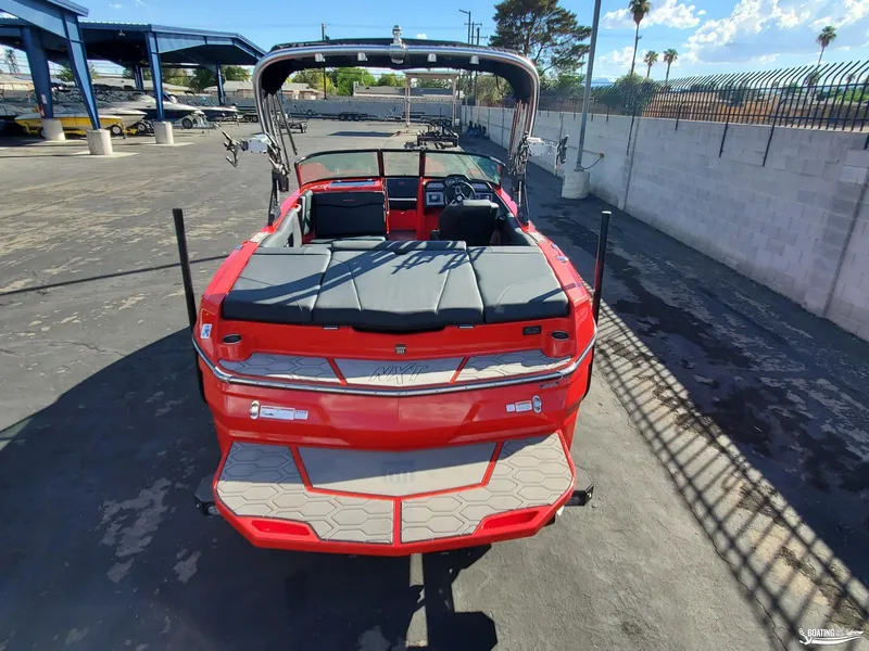 Slide: The Image of Red 2020 MasterCraft NXT20 boat parked in a marina, rear view. - 8