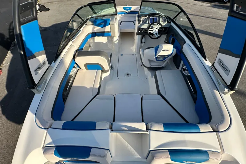 Slide: The Image of 2019 Chaparral Vortex 2430 VRX boat interior with blue and white seating. - 13
