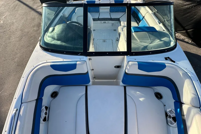 Slide: The Image of 2019 Chaparral Vortex 2430 VRX boat interior with blue and white seating. - 24