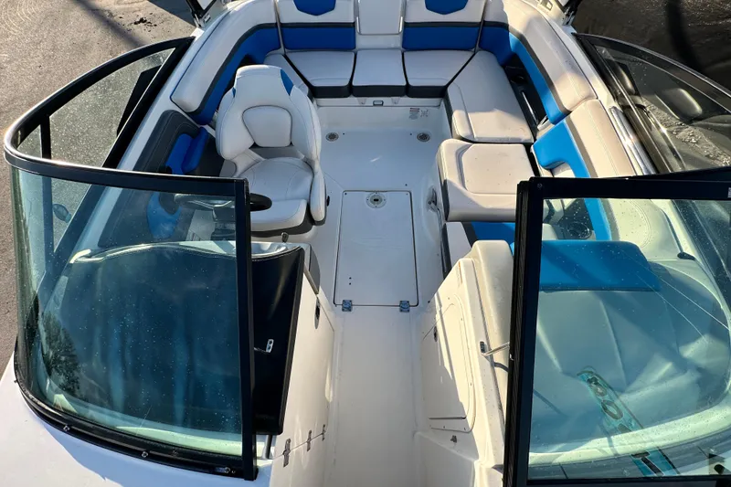 Slide: The Image of 2019 Chaparral Vortex 2430 VRX boat interior with blue and white seating. - 25