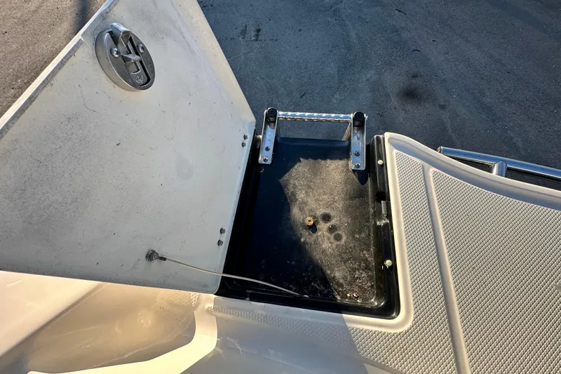 Slide: The Image of 2019 Chaparral Vortex 2430 VRX boat compartment with open hatch and ladder. - 31