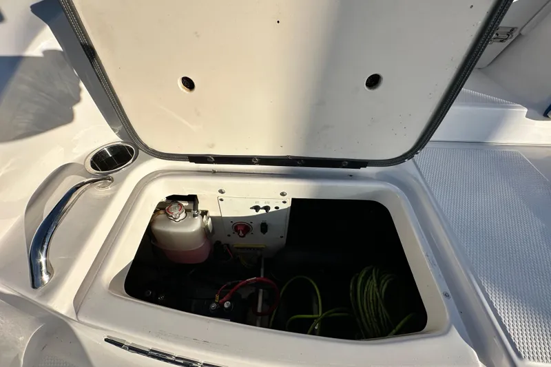 Slide: The Image of Open storage compartment in 2019 Chaparral Vortex 2430 VRX boat, showing interior components. - 36