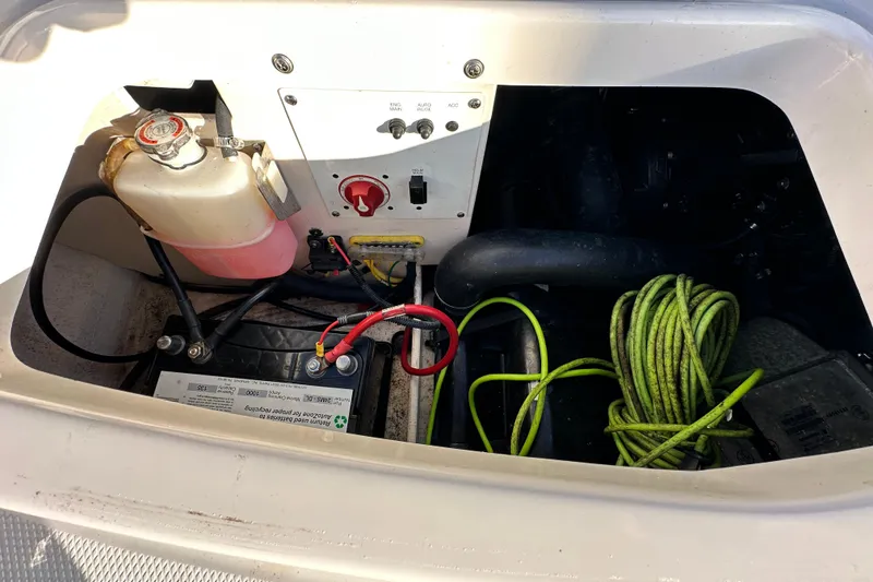 Slide: The Image of 2019 Chaparral Vortex 2430 VRX engine compartment with battery, cables, and coolant tank. - 37