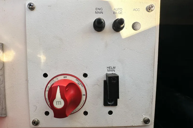 Slide: The Image of Control panel of a 2019 Chaparral Vortex 2430 VRX boat with switches and a red dial. - 38