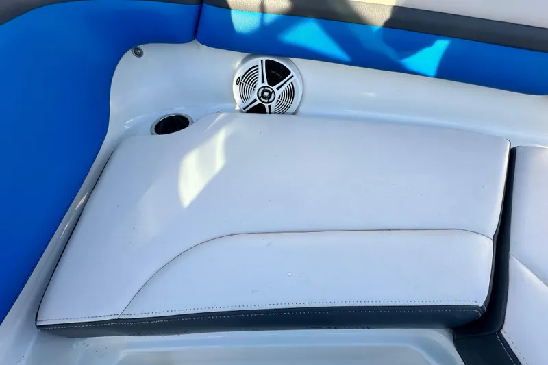 Slide: The Image of 2019 Chaparral Vortex 2430 VRX boat interior with blue and white seating and speaker. - 69