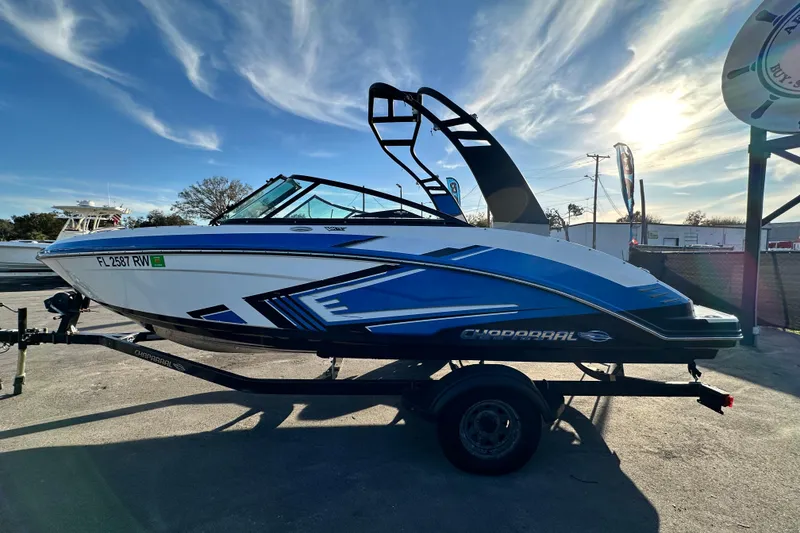 Slide: The Image of 2019 Chaparral Vortex 2430 VRX boat on trailer under a bright sky. - 7
