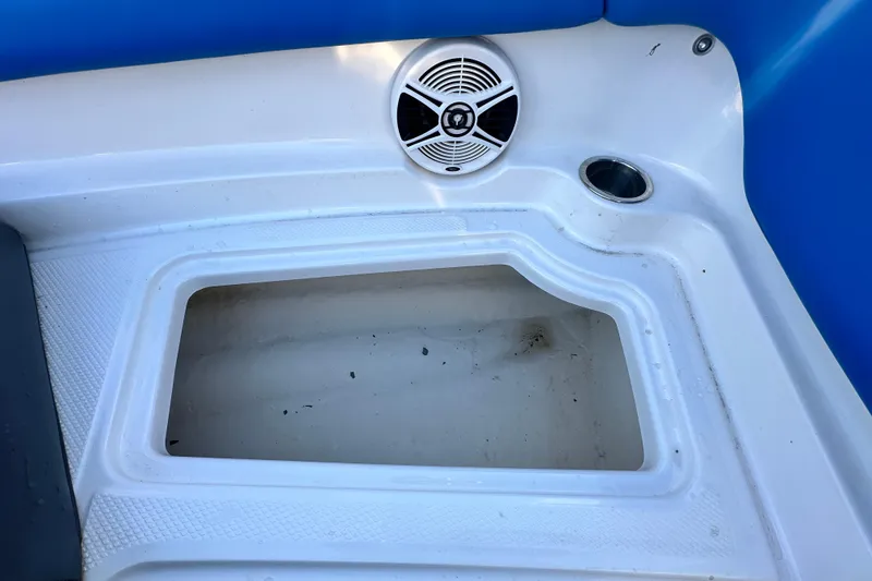 Slide: The Image of 2019 Chaparral Vortex 2430 VRX boat storage compartment with speaker and cup holder. - 77