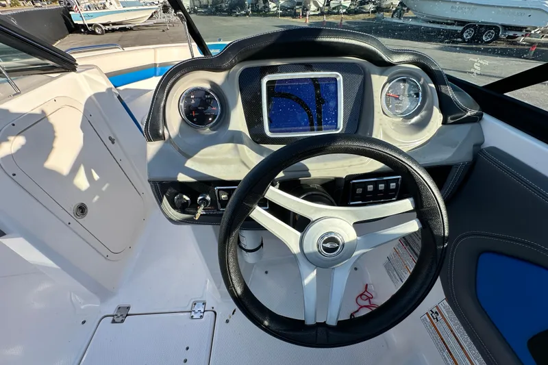 Slide: The Image of 2019 Chaparral Vortex 2430 VRX boat dashboard with steering wheel and gauges. - 79